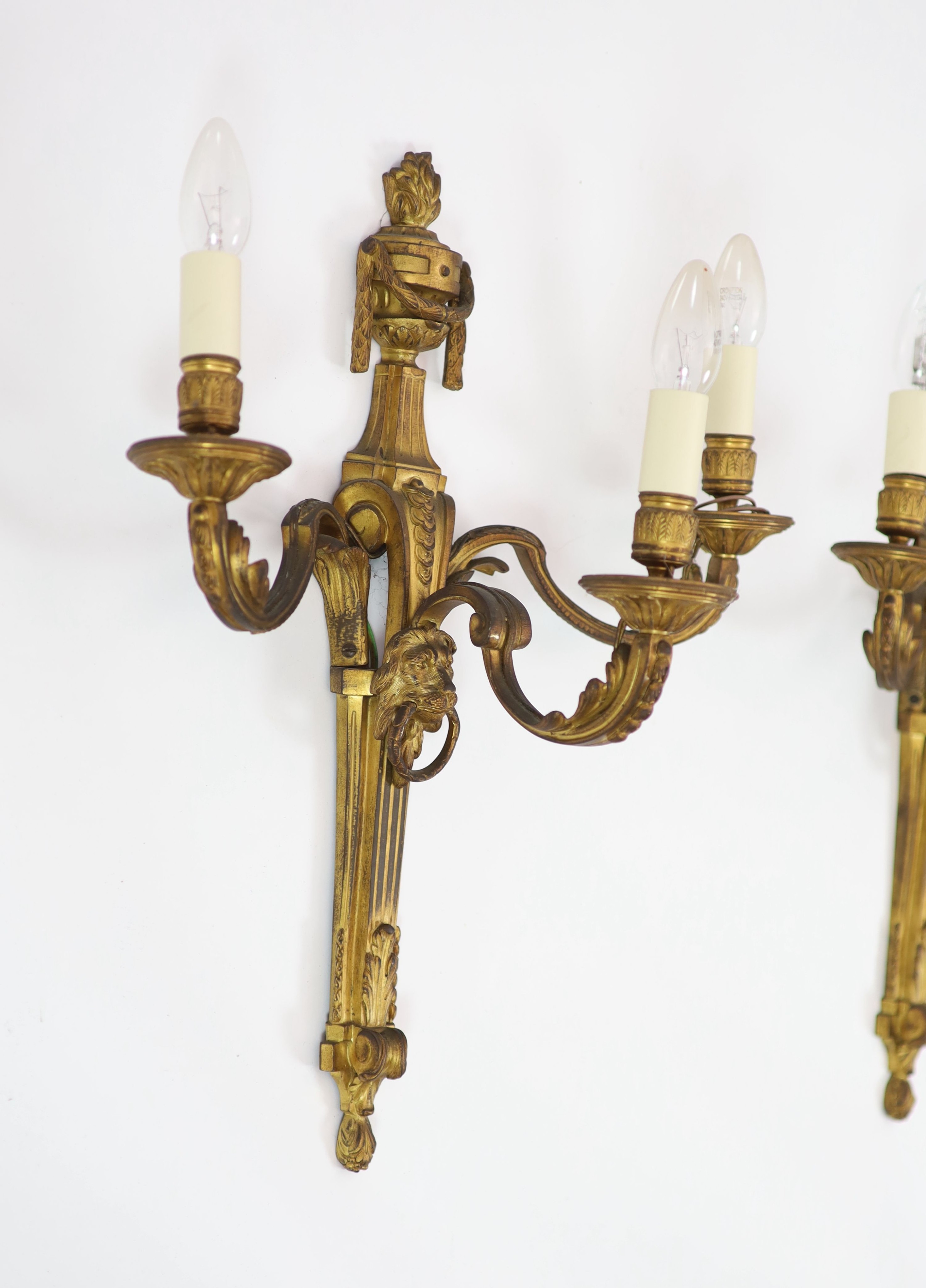 A pair of Louis XVI style ormolu three branch wall lights H 55cm. W 45cm.